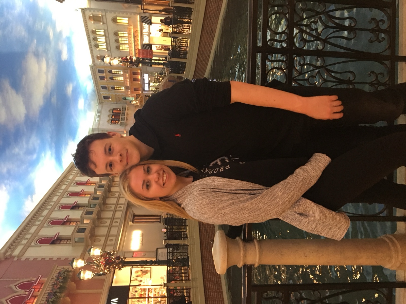 Chloe and Owain posing by an indoor Venetian-style canal