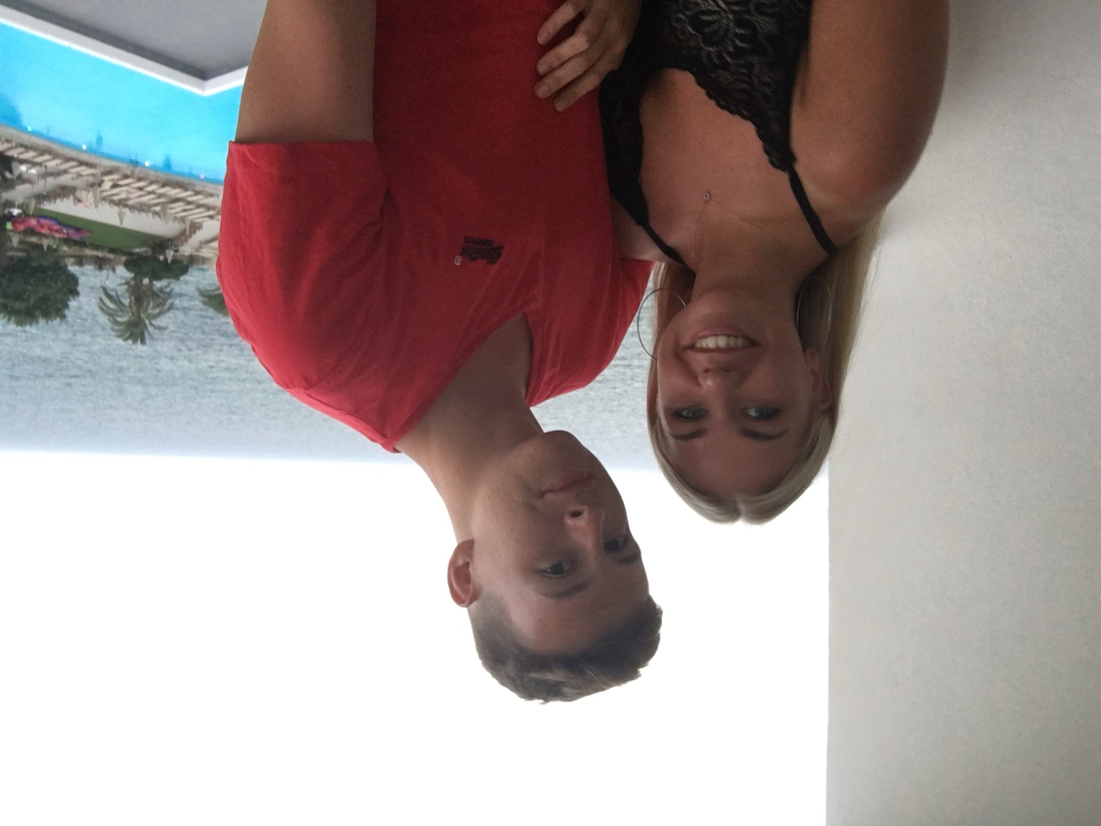Chloe and Owain on a holiday balcony overlooking the sea