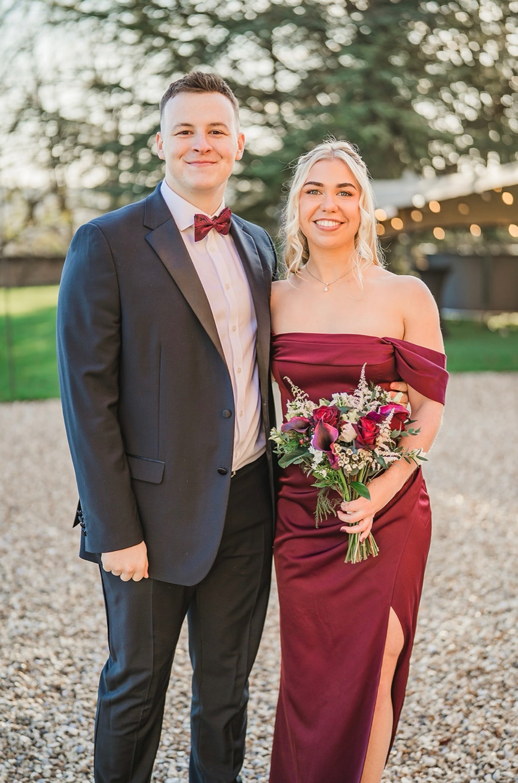 Chloe and Owain dressed up together at an outdoor celebration